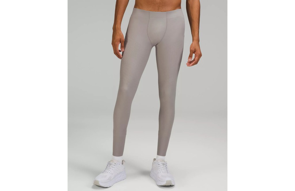 A model wears gray running tights. 