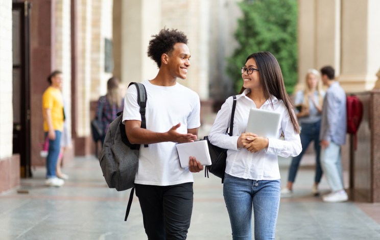 College students smile after paying off loans