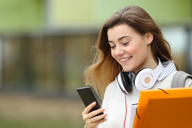 Student smiles after being approved for a loan