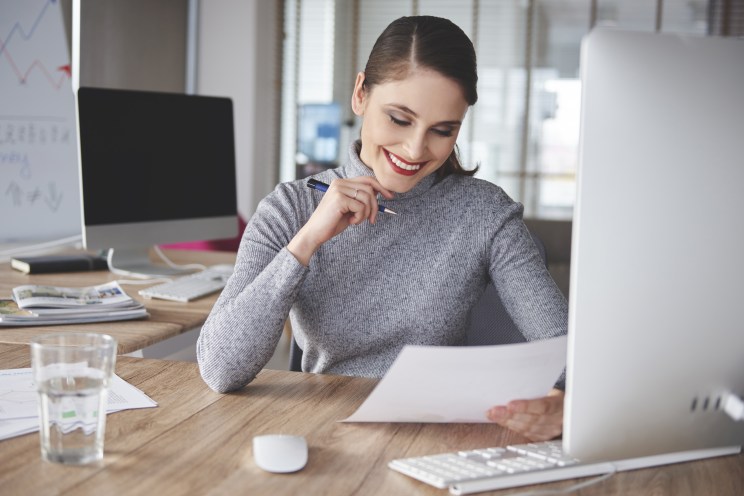 Woman excitedly reviews approval for $50,000 loan