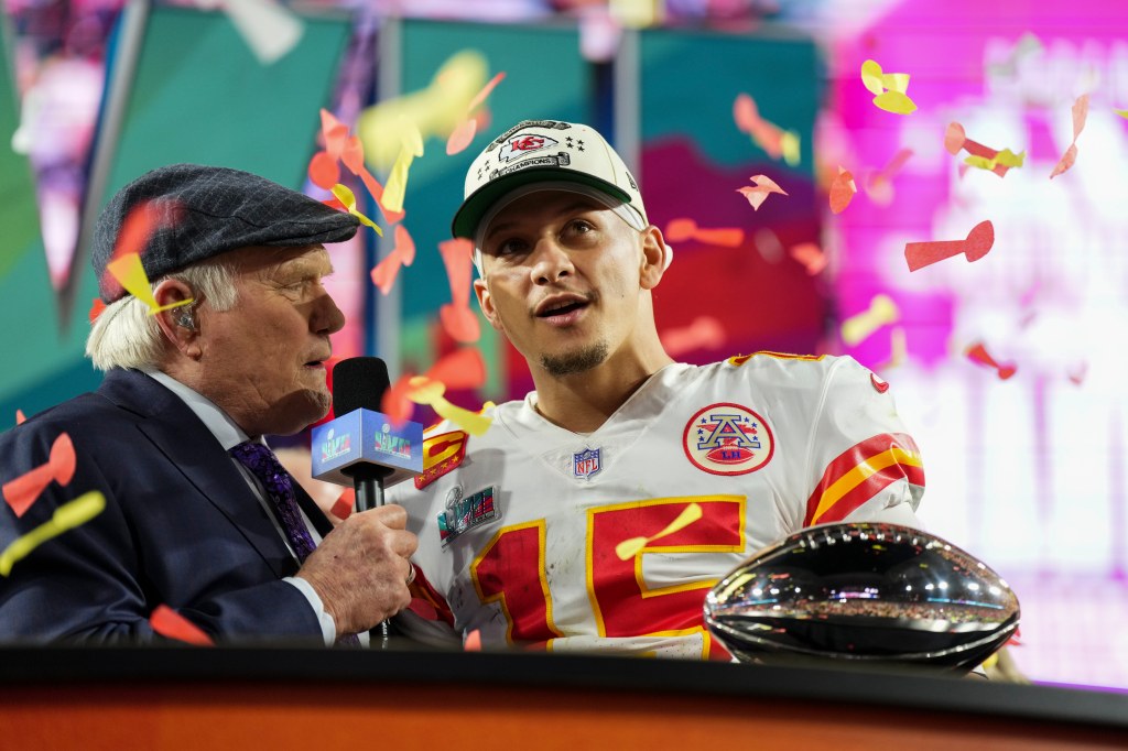 Patrick Mahomes #15 of the Kansas City Chiefs speaks with Terry Bradshaw after Super Bowl LVII win.