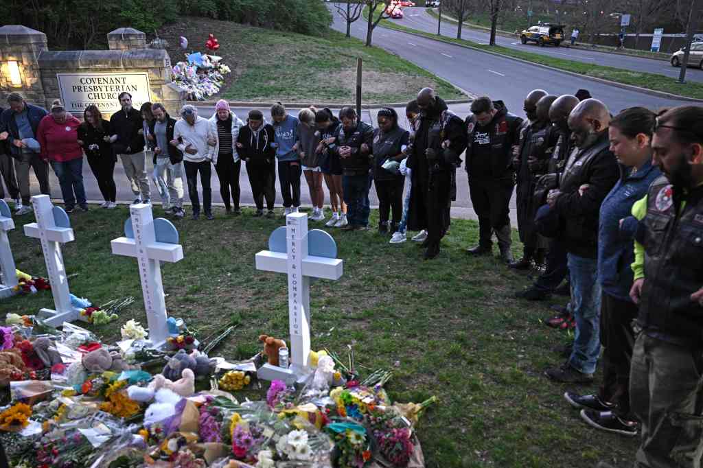 Members of the Selected First Motorcycle Club join others in prayer at a makeshift memorial for victims of a shooting at the Covenant School campus, in Nashville, Tennessee, March 28, 2023.