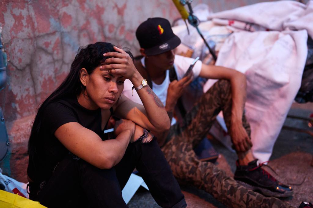 Migrants gather outside Sacred Heart Church on Monday, May 1, 2023 in El Paso, Texas.