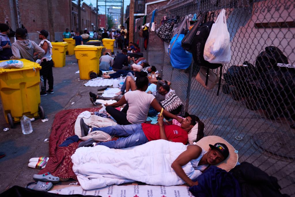 Migrants gather outside Sacred Heart Church on Monday, May 1, 2023 in El Paso, Texas.