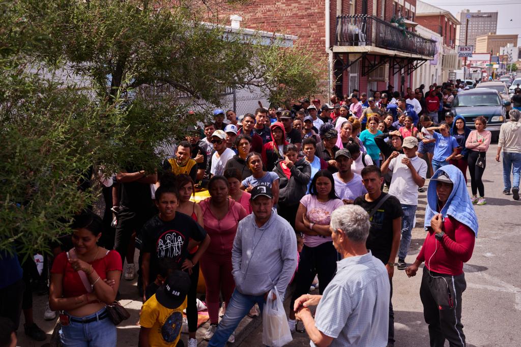 Migrants standing in line for donated meals at Sacred Heart Church in El Paso, Texas on May 2, 2023.