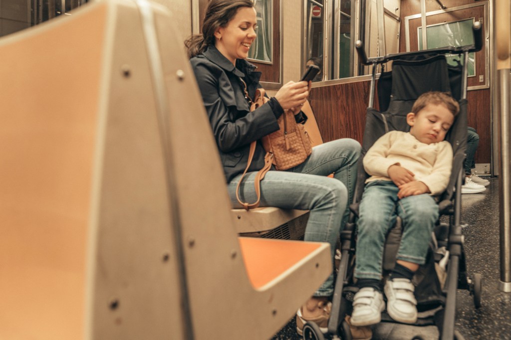 Mom on subway with child.