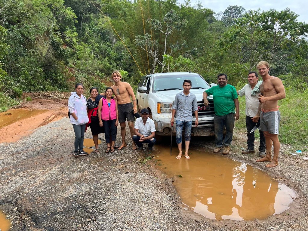 Daniel Penny (far right) with locals from Oaxaca, Mexico that helped dig out his car after it got stuck in a land slide from after a hurricane in the enchanted Forrest.