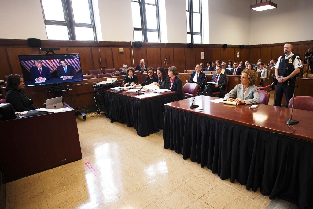 Donald Trump appears by video, as his other attorney Susan Necheles, right, looks on, during a hearing in Manhattan criminal court.