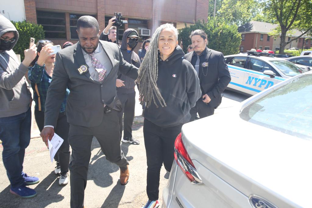 A smirking Shellyne Rodriguez, 45, held her head high as she was escorted out of the 43rd Precinct in the Bronx in handcuffs just after 11 a.m.