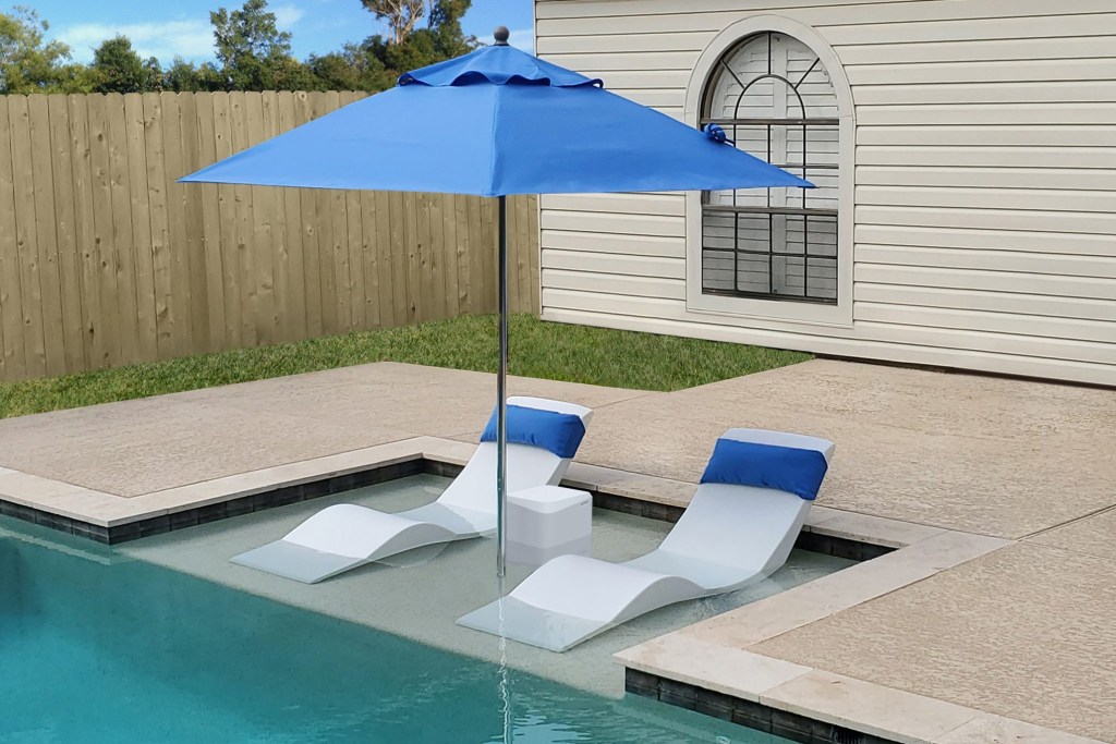 white loungers in the pool under an umbrella