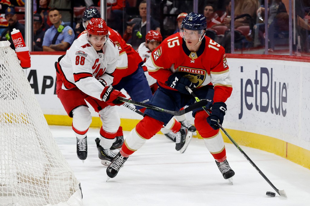 Anton Lundell #15 of the Florida Panthers skates with the puck against Martin Necas #88 of the Carolina Hurricanes