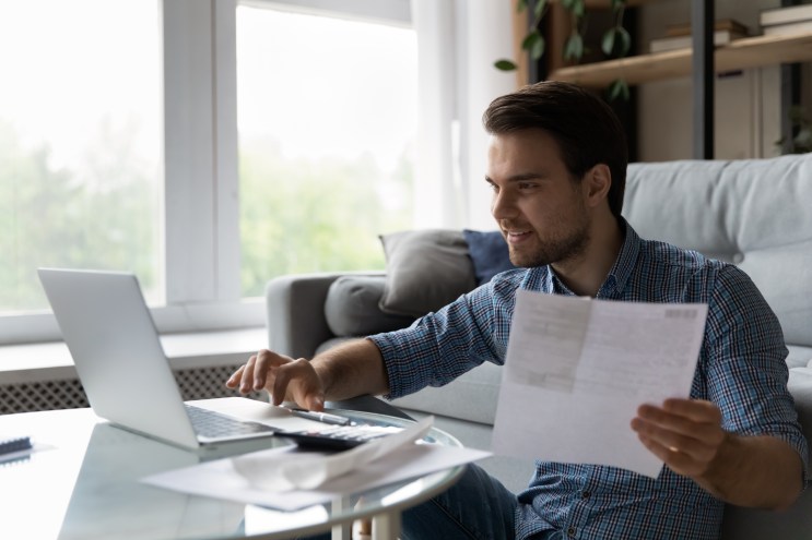 Unemployed man smiles as he's approved for a loan