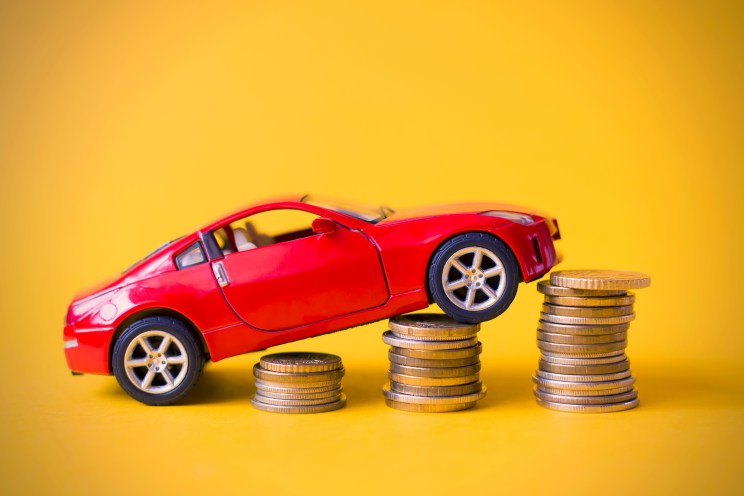 Toy car on a pile of coins