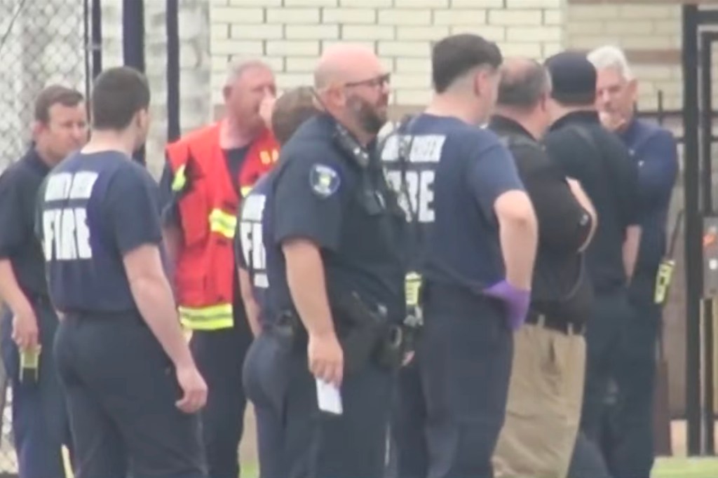 Emergency responders gather outside Caney Creek High School on Thursday.