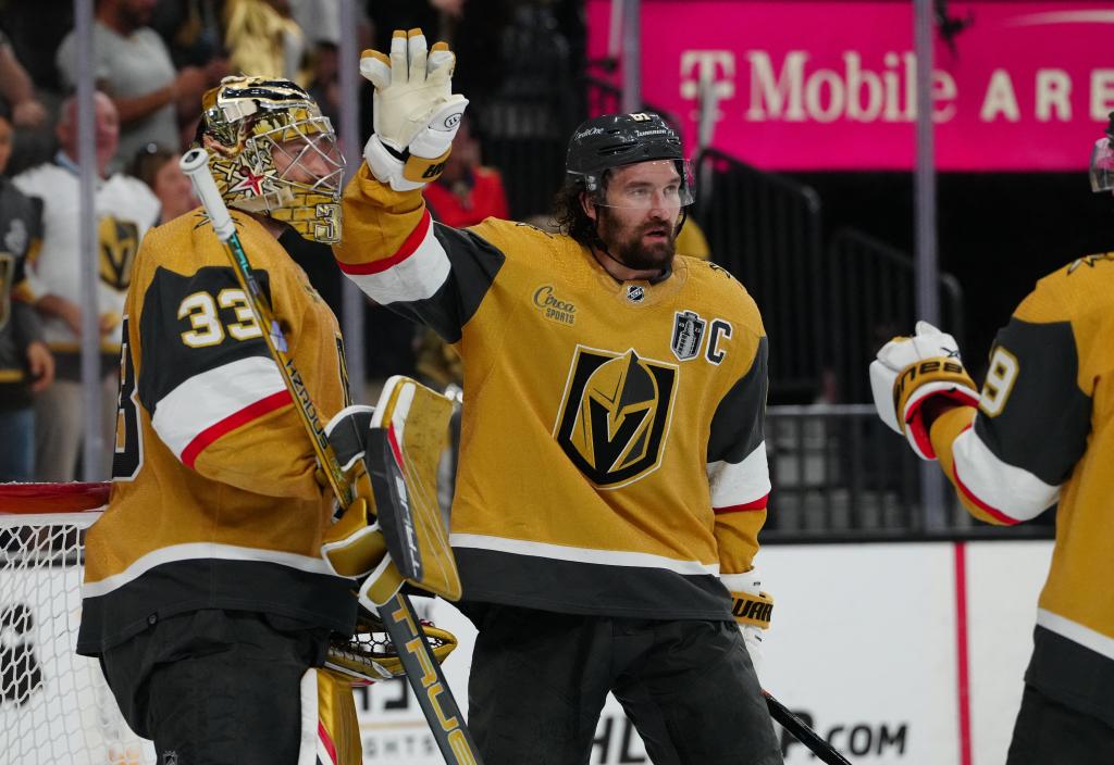 Golden Knights goaltender Adin Hill (33) celebrates with right wing Mark Stone.