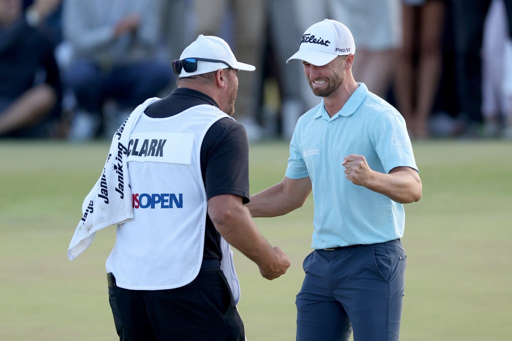 Clark of the United States reacts with his caddie John Ellis after his winning putt on the 18th green during the final round of the 123rd U.S. Open Championship at The Los Angeles Country Club on June 18, 2023