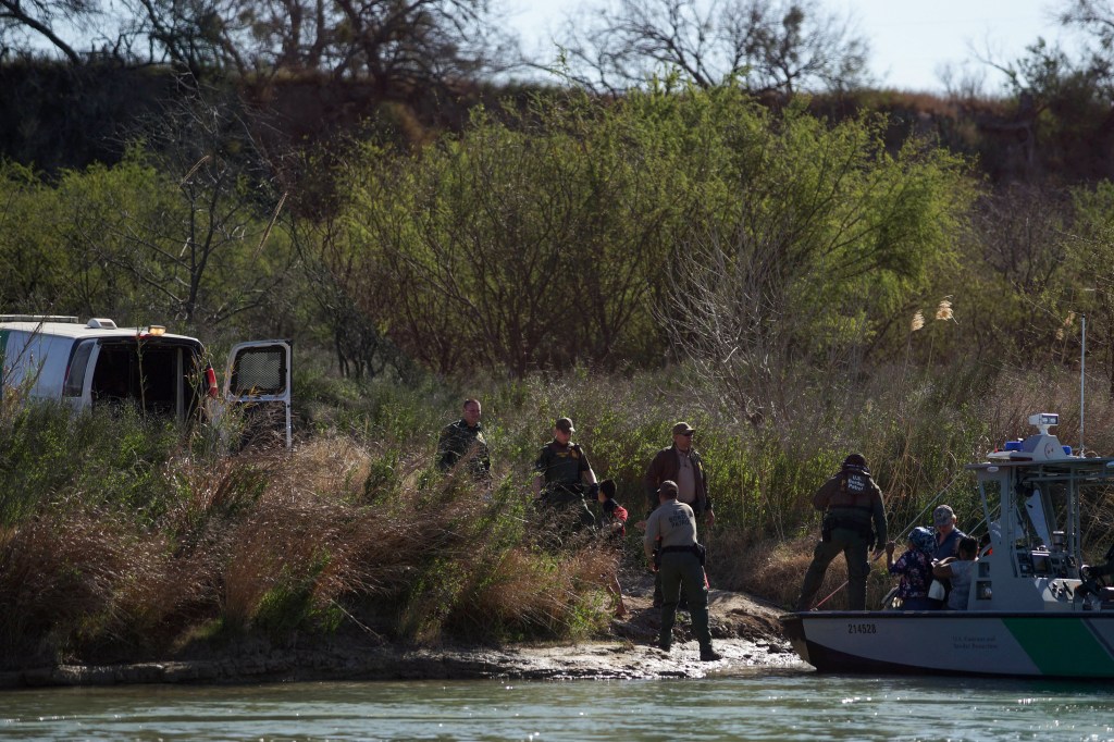 Central American migrants are taken into custody after being detained by members of the U.S. Border Patrol during their attempt to cross the Rio Bravo from Piedras Negras, in Coahuila state, Mexico to Eagle Pass, in Texas.