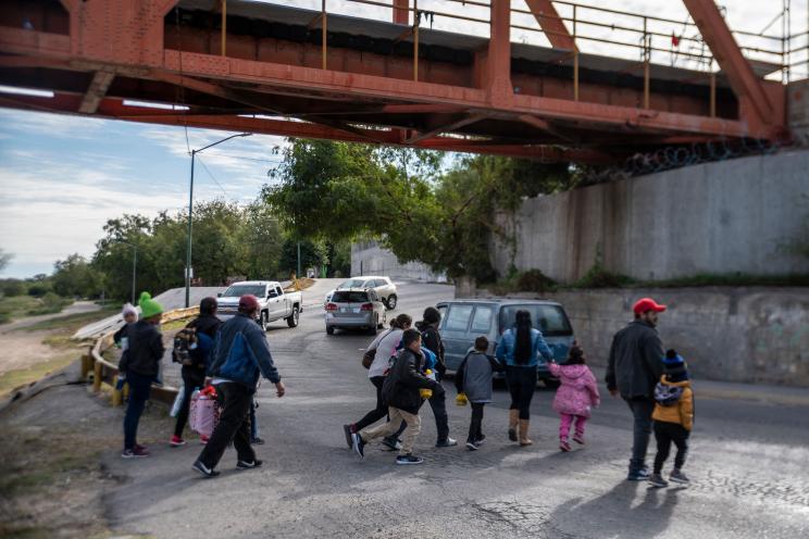 A group of migrants cross the street in Piedras Negras, Mexico on November 16, 2022.