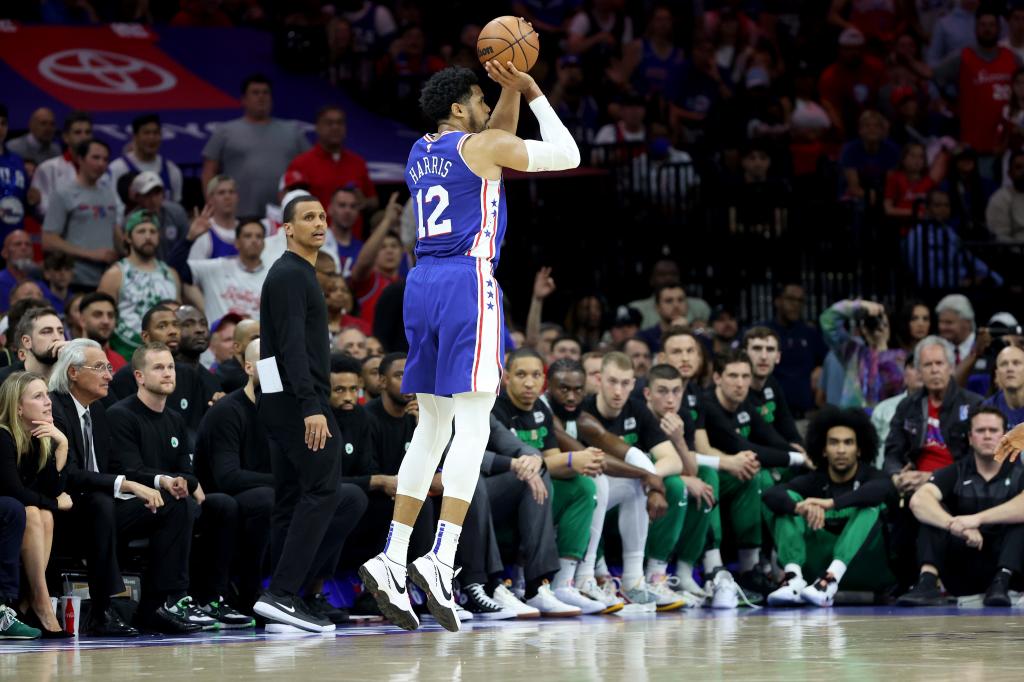 Harris #12 of the Philadelphia 76ers shoots a three point basket against the Boston Celtics.