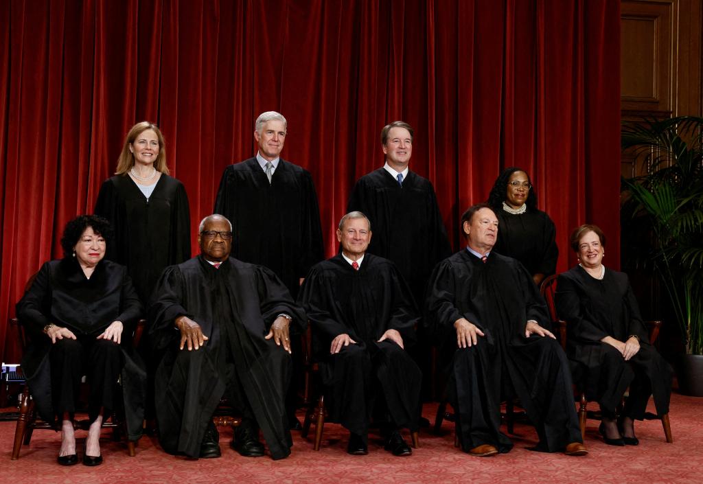 U.S. Supreme Court justices (seated L-R): Justices Sonia Sotomayor, Clarence Thomas, Chief Justice John G. Roberts, Jr., Samuel A. Alito, Jr., and Elena Kagan. Standing (L-R): Justices Amy Coney Barrett, Neil M. Gorsuch, Brett M. Kavanaugh and Ketanji Brown Jackson.