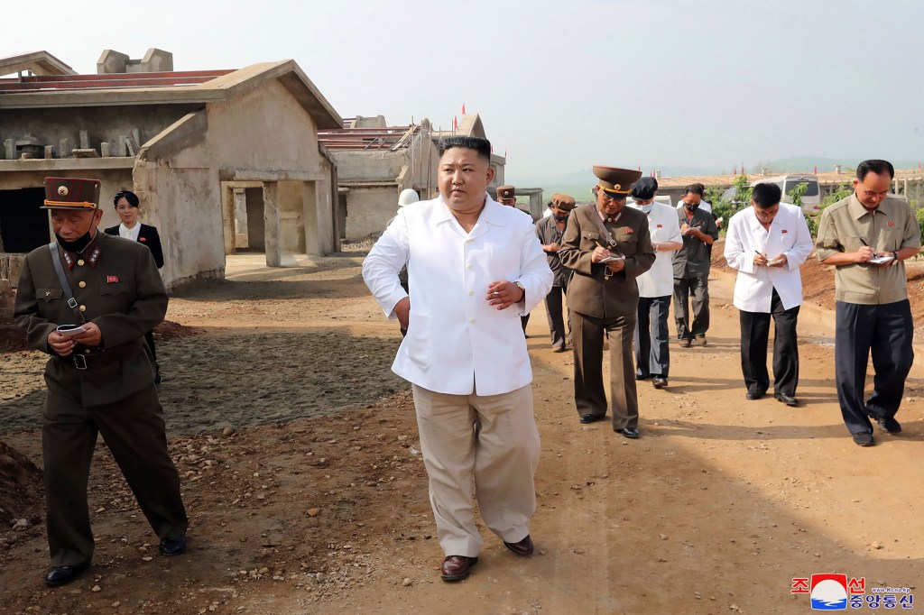 North Korean leader Kim Jong Un, center, visits a new chicken farm being built in Hwangju County, North Korea. Independent