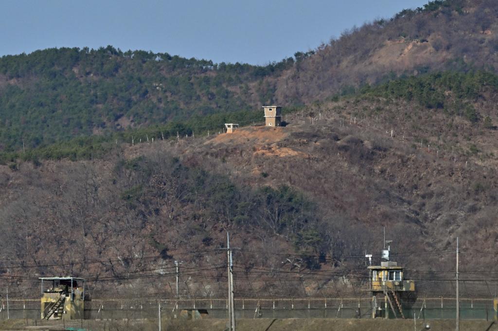  North Korean guard post (top) is seen over a South Korean military fence (bottom) from the border city of Paju.