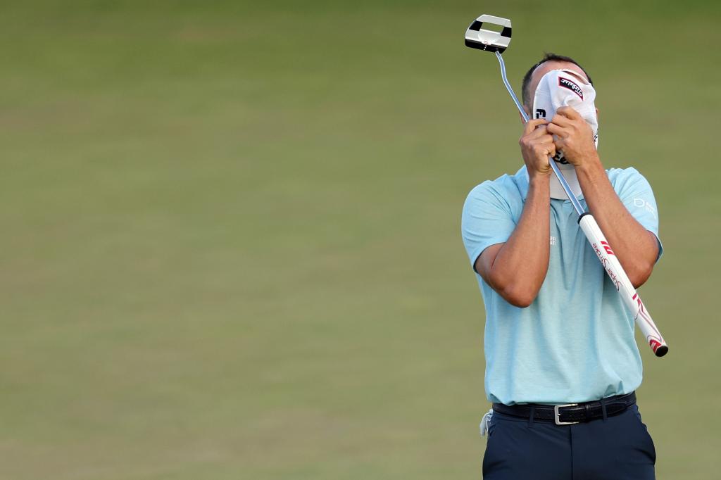 Wyndham Clark reacts to his winning putt on the 18th green.