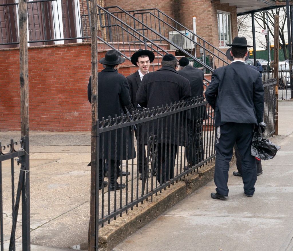 Hasidic Jewish students gather at the entrance of a private yeshiva (school) in Borough Park area of Brooklyn