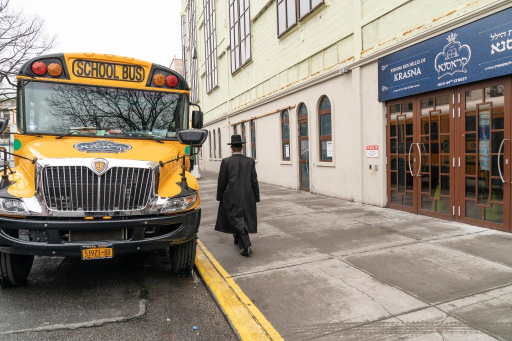 Hasidic Jewish students gather at the entrance of a private yeshiva (school) in Borough Park area of Brooklyn