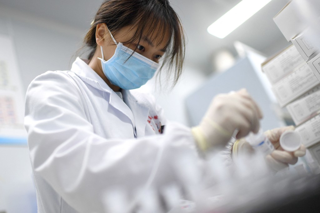 a laboratory technician conducting artificial intelligence (AI)-based cervical cancer screening at a test facility in Wuhan, in China's central Hubei province.