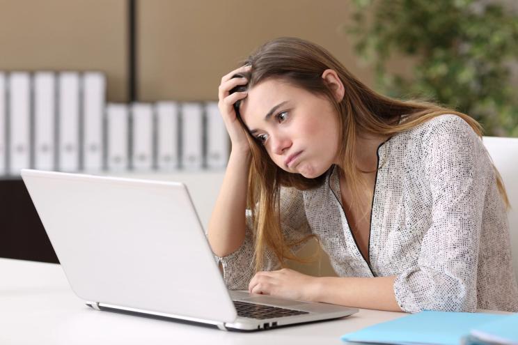 Woman stressed on computer.