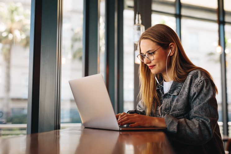 Recent graduate makes a student loan payment online after her grace period ends.