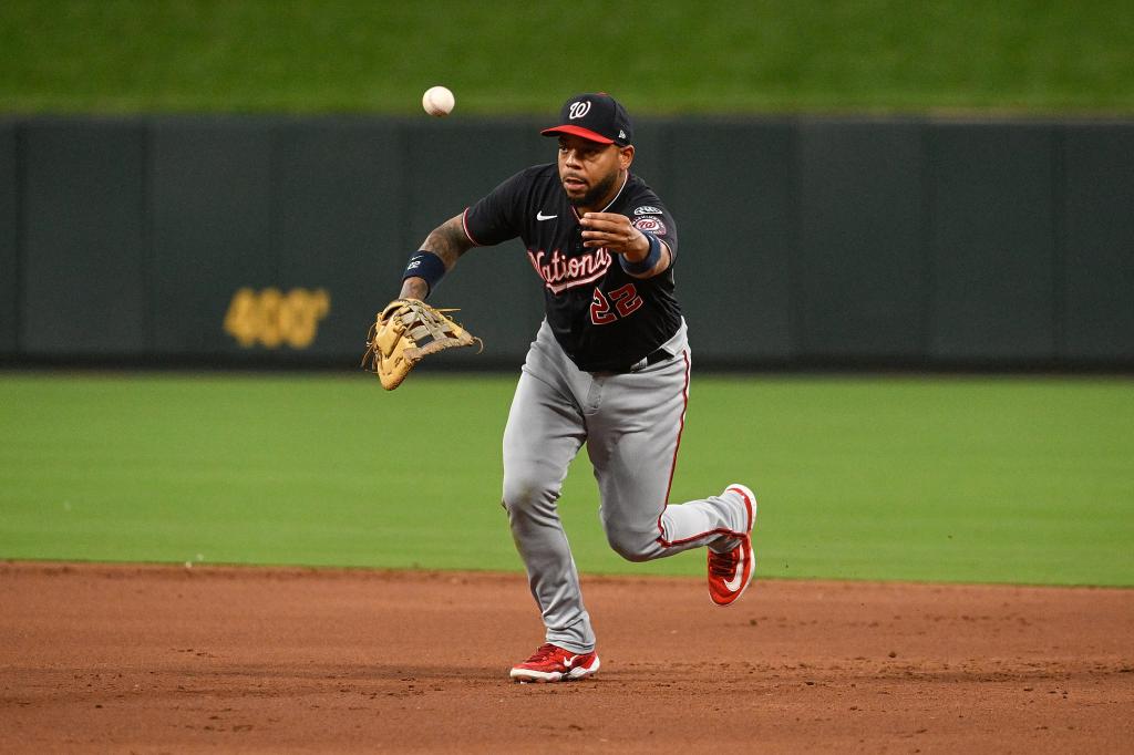 Dominic Smith #22 of the Washington Nationals tosses to first for an out against the St. Louis Cardinals in the third inning at Busch Stadium on July 14, 2023 in St Louis, Missouri. 