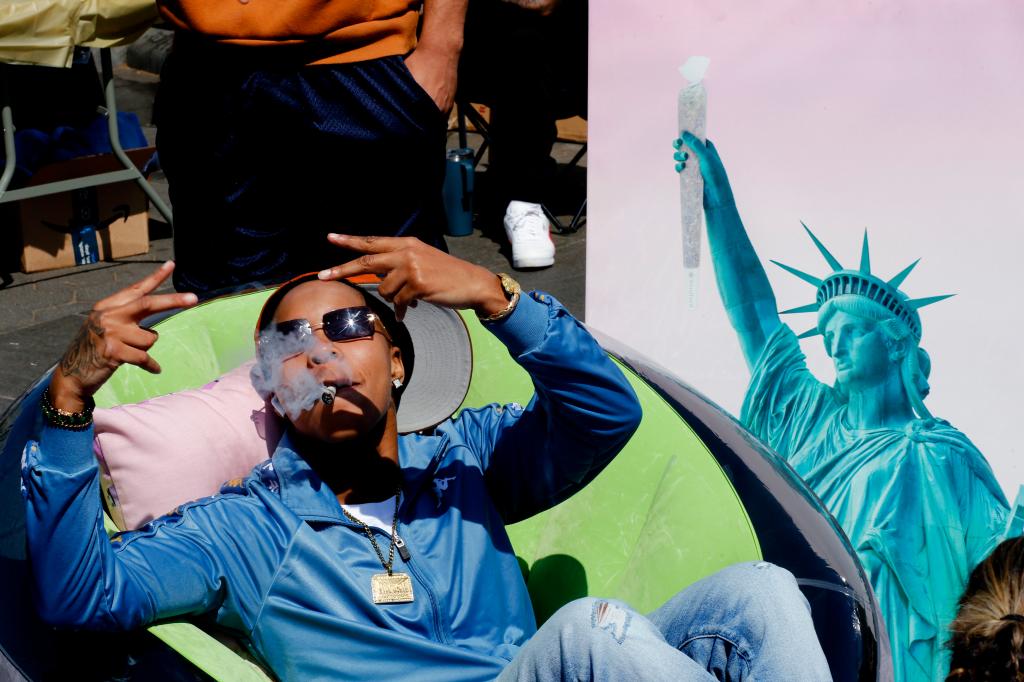 A woman smokes a marijuana cigarette at Washington Square Park on April 20, 2023 in New York City. 