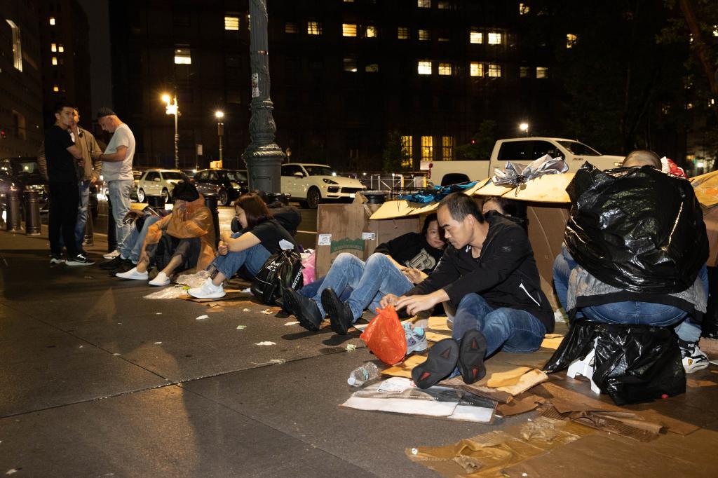 migrants sitting on the floor