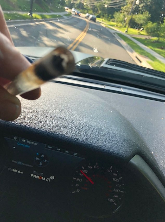 Another photo shows him flashing his crack pipe while driving in an Arlington, Virginia, neighborhood. 