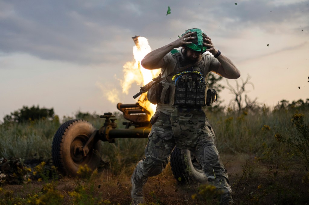 Soldier ducking from an explosion in Ukraine