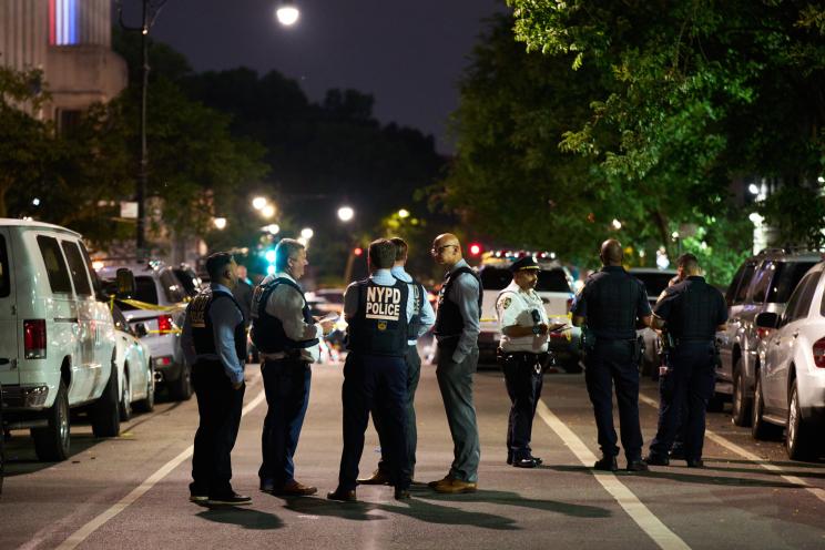 Police investigate the scene of a triple shooting in the Bronx Monday night.