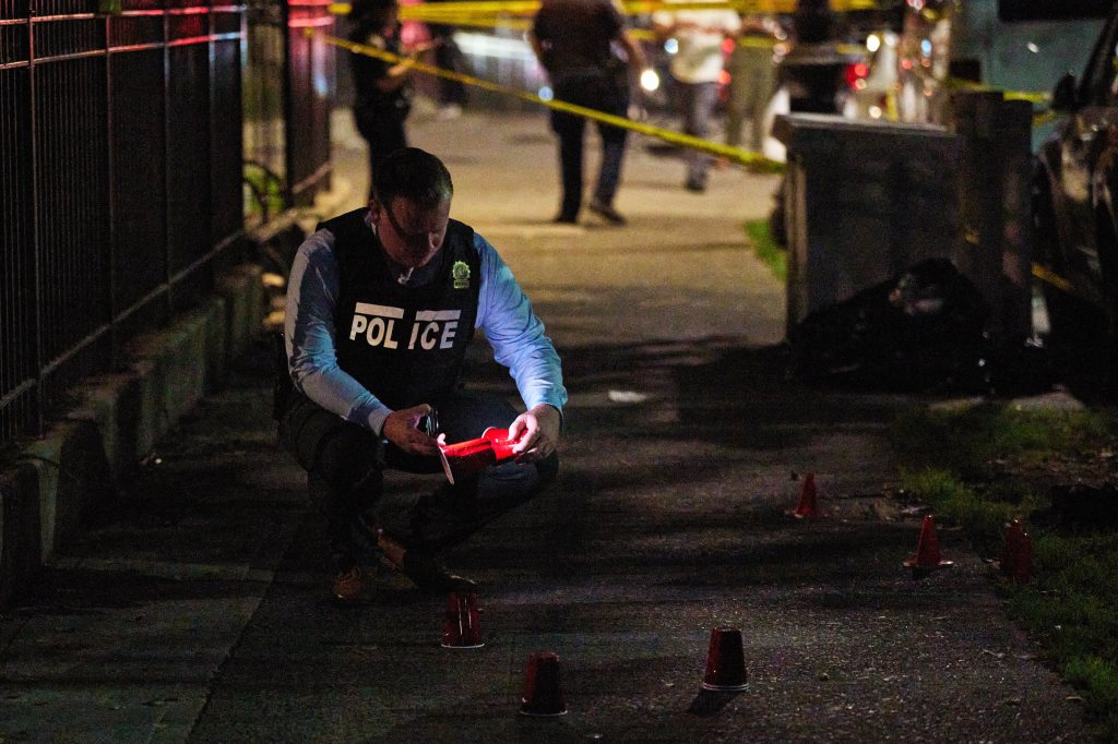 Police investigate the scene of a shooting in the Bronx Monday night. 