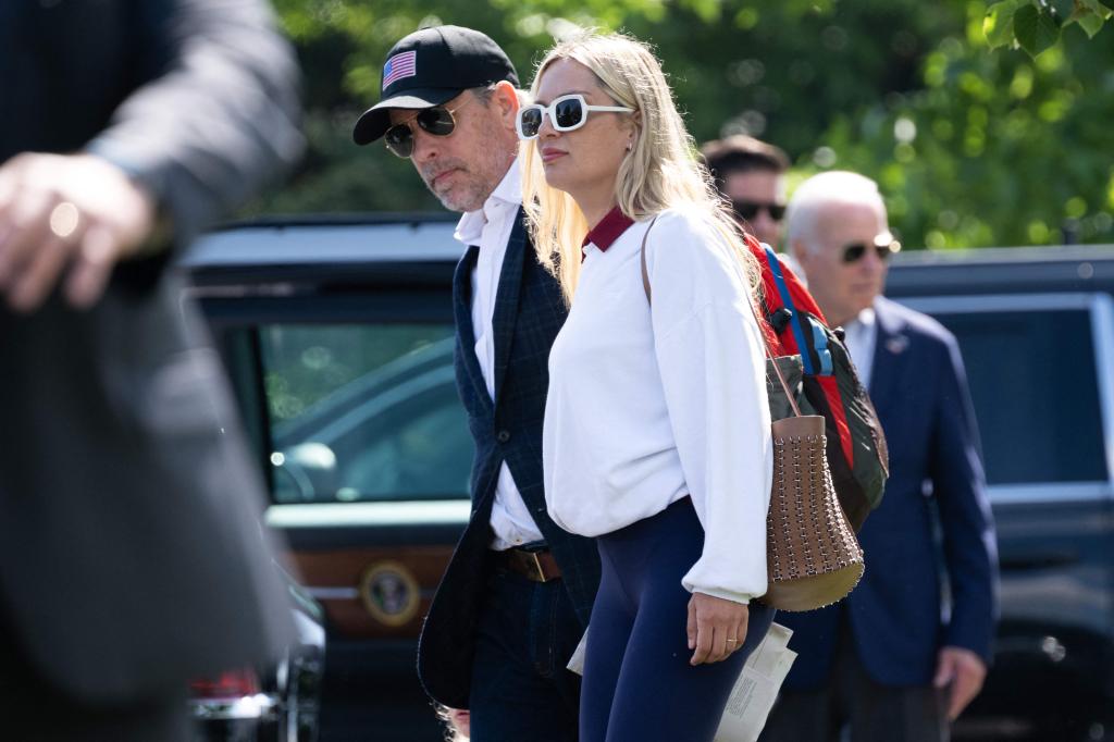 US President Joe Biden waits near his SUV after arriving on Marine One with his son Hunter Biden (L), and his wife, Melissa Cohen (C), at Fort McNair in Washington, DC, July 4, 2023.