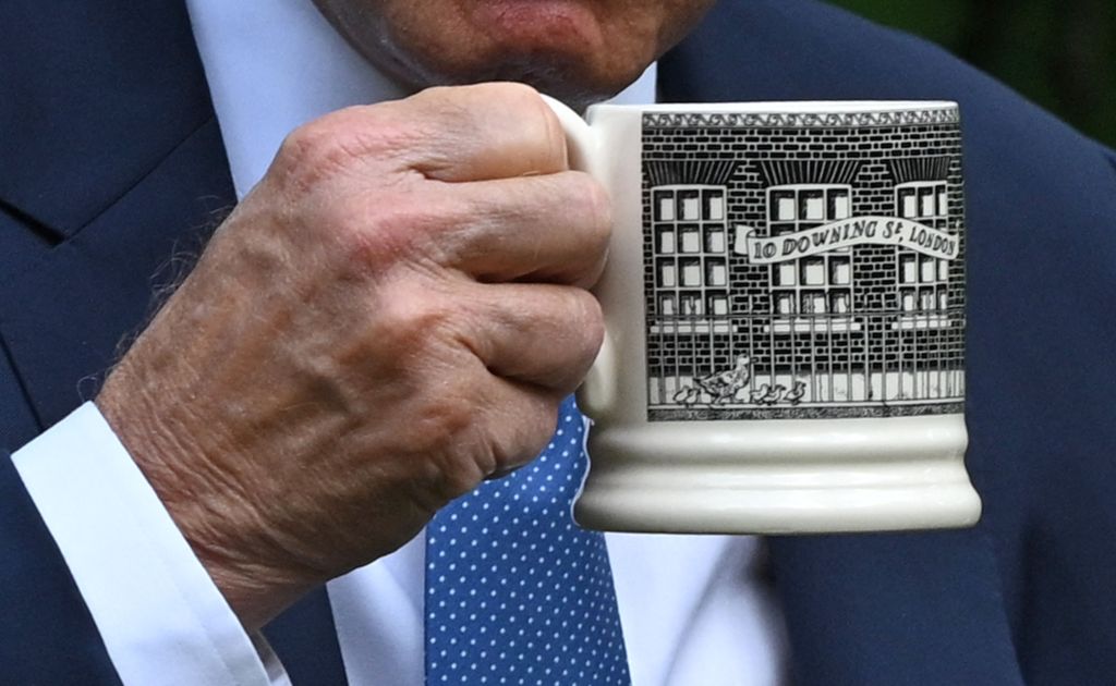 Biden holding special 10 Downing Street mug.