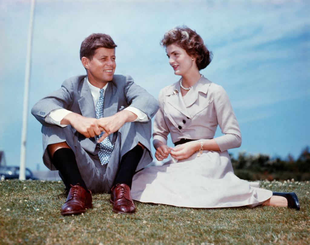 An undated photo of John F. Kennedy and Jacqueline Bouvier sitting together in the sunshine at Kennedy's family home at Hyannis Port, Massachusetts