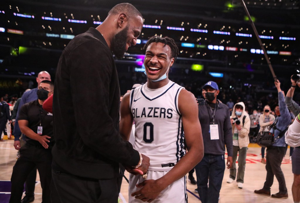 Lebron James comes onto the court to congratulate his son Bronny James (0) point guard for Sierra Canyon