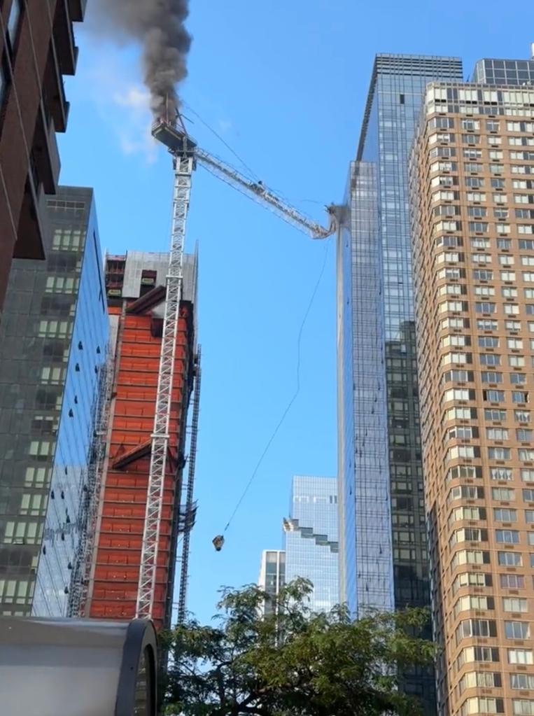 A construction crane's tethers snapped due to a fire, causing the machine to slam against a building across the street.  