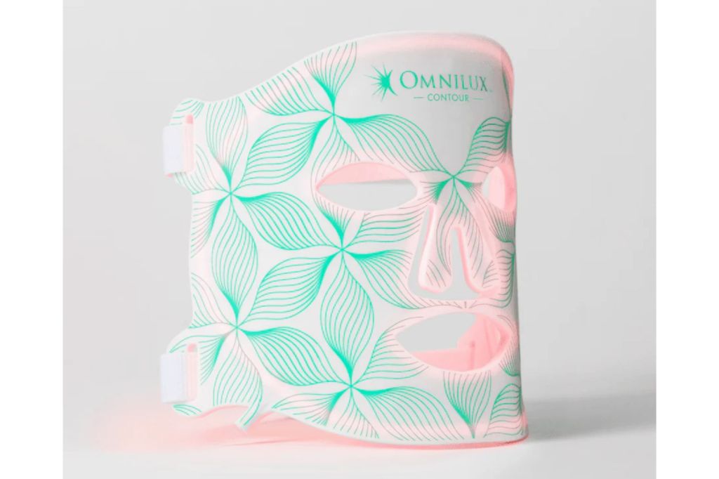 An Omnilux face mask lit up