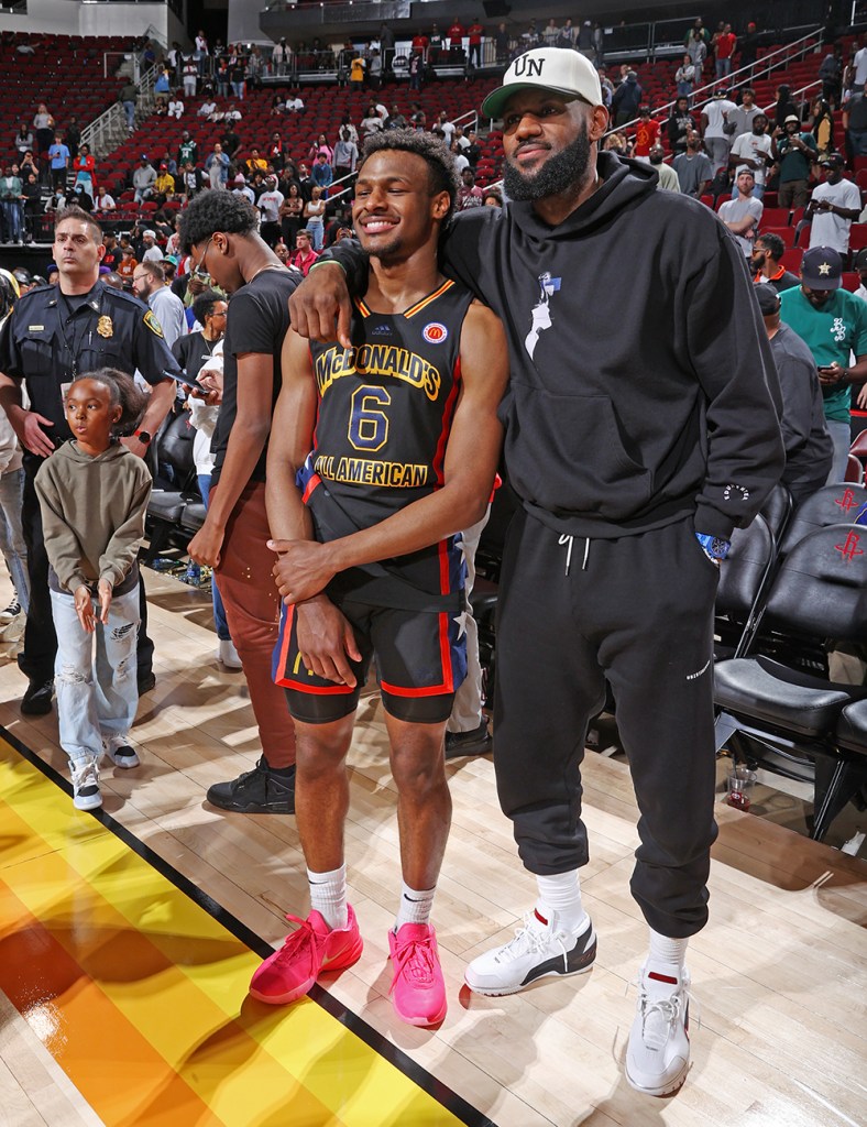 McDonalds High School All American Bronny James (6) talks with his father LeBron James after the 2023 McDonalds High School All American Boys Game at Toyota Center.  