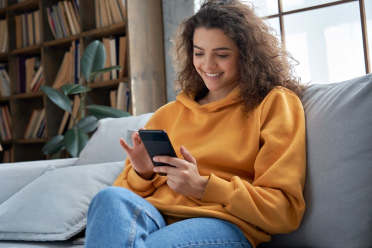 Borrower smiles after paying off her student debt