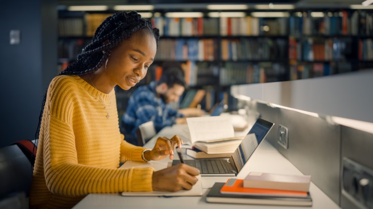 Student in library after learning how to pay loans with a credit card