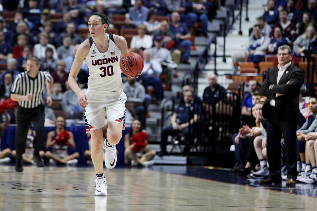 Breanna Stewart brings the ball up the floor under the watchful eye of UConn coach Geno Auriemma.