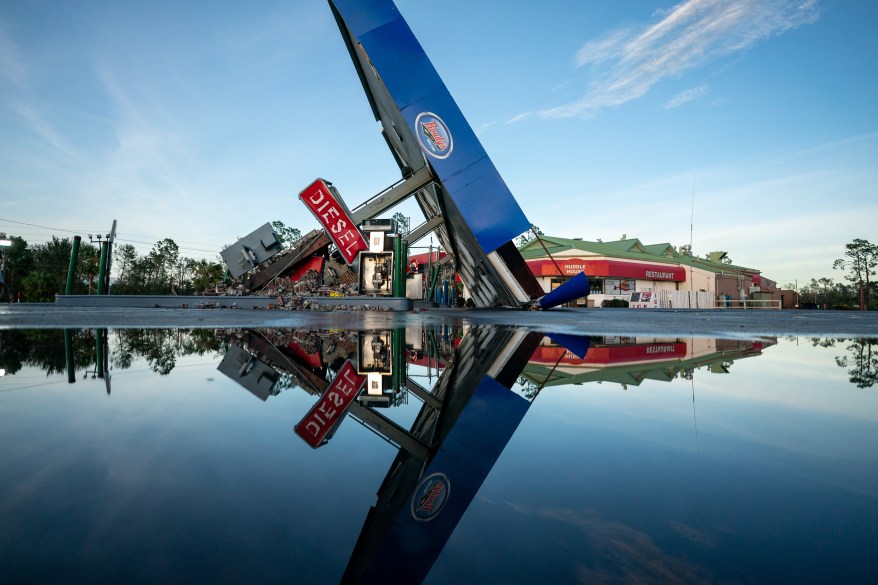 A gas station signed fell down to the ground in the wake of Hurricane Idalia.